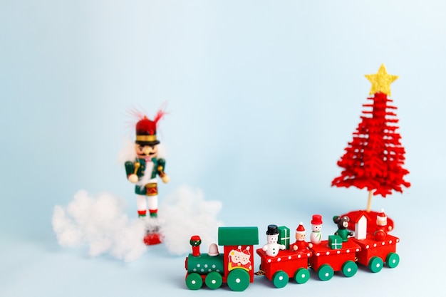 Little red christmas toy train on blue background