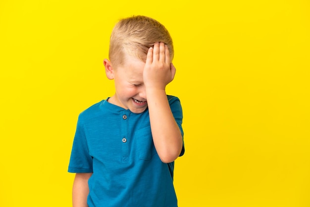 Little Russian boy isolated on yellow background has realized something and intending the solution