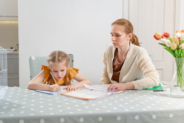 A little schoolgirl does her homework.