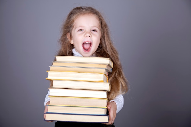 Little schoolgirl with books. 