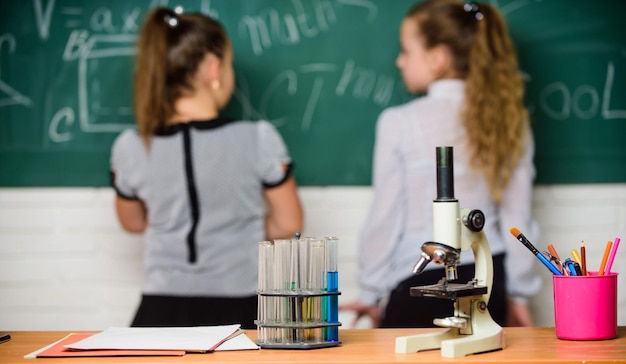 Little scientist work with chemistry microscope Chemistry research Biology lesson Back to school science experiments in chemistry laboratory Little girls in school lab Chemistry education