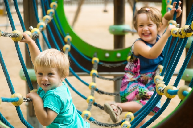 little sisters at action-oriented playground  