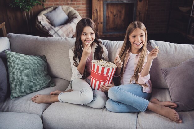 Little sisters posing on the couch together