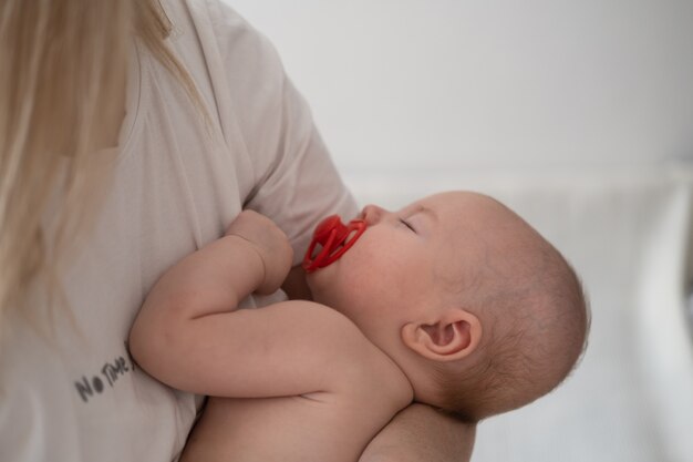 Little sleeping baby boys face in mother hands. motherhood concept. nipple. Happy family. Endless love. nursing mom. relax with small son. At home. Love. Sweet. Tenderness. High quality photo