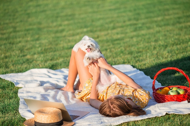 Little smiling girl with her dog in the park