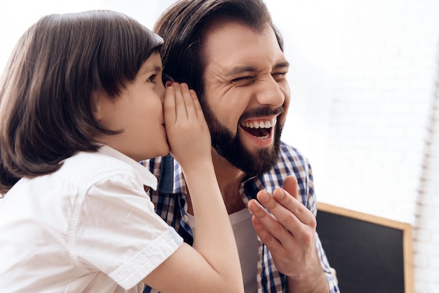 Little son told dad a joke dad laughs.