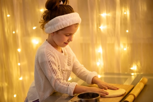 A little sweet girl makes Christmas cookies House New Year Comfort