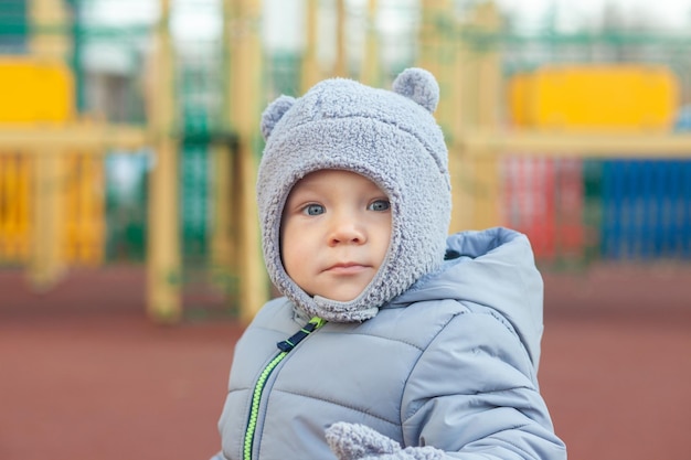 Little toddler boy having fun on playground outdoors