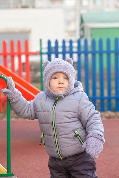 Little toddler boy having fun on playground outdoors