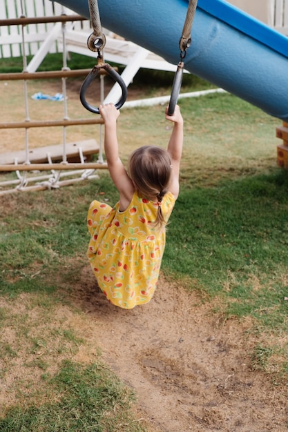 Little toddler girl playing on the kids playground