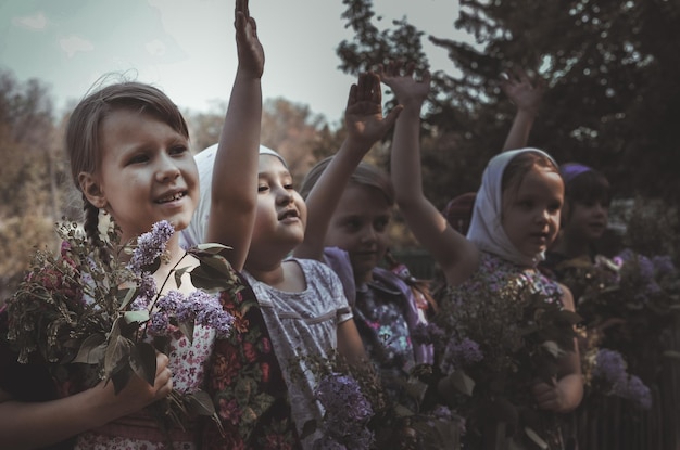 little village girls of different nationalities accompany people to war at the old wooden fence