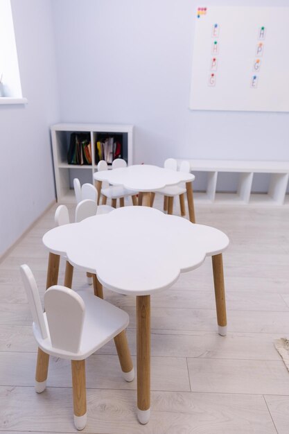 Little white table for kids in private kindergarten development and education of children