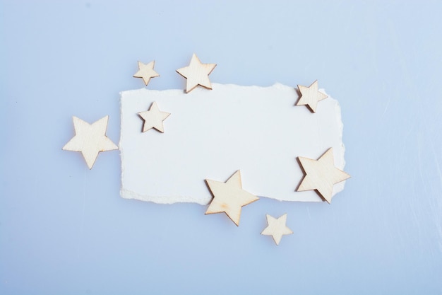 Little wooden stars on torn paper