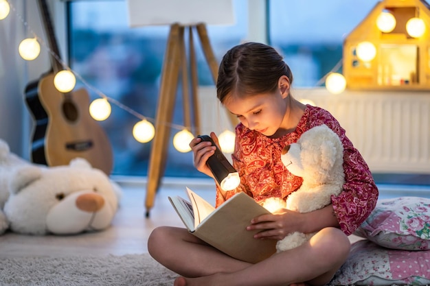 Litttle girl reads the book