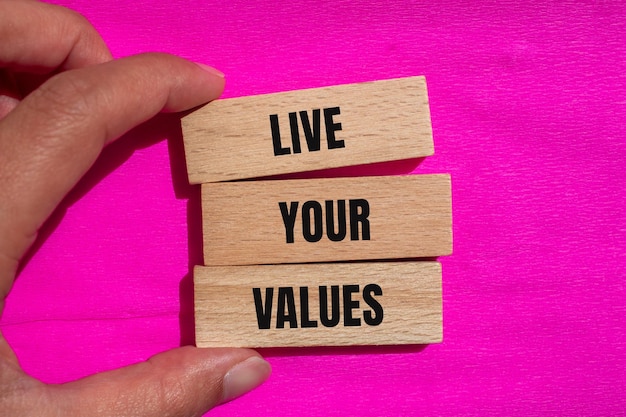 Photo live your values words written on wooden blocks with pink background conceptual live your values symbol copy space