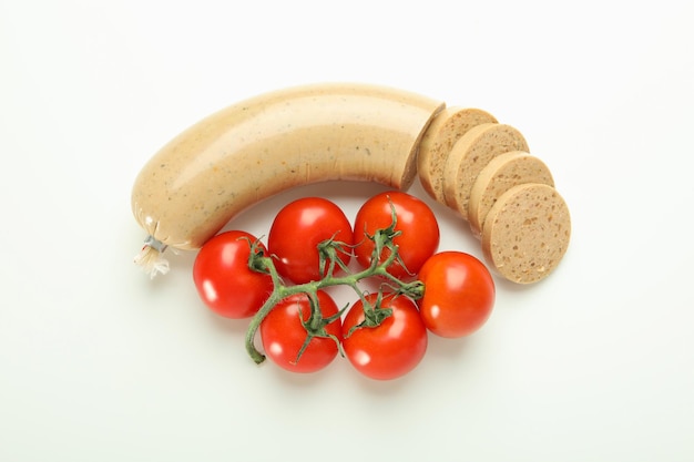 Liverwurst sausage and tomatoes on white background top view