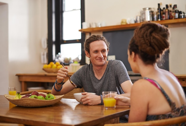 Living all natural Shot of a happy couple with dreadlocks sitting down to breakfast