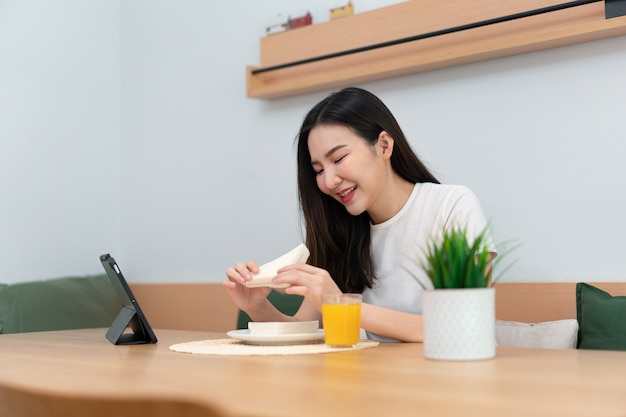 Living room concept a woman using her electronic device to work remotely in the cozy room of the coffee shop.