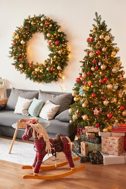 Living room interior Christmas tree and wreath New Year celebration Vacation rentals Winter holidays and vacations