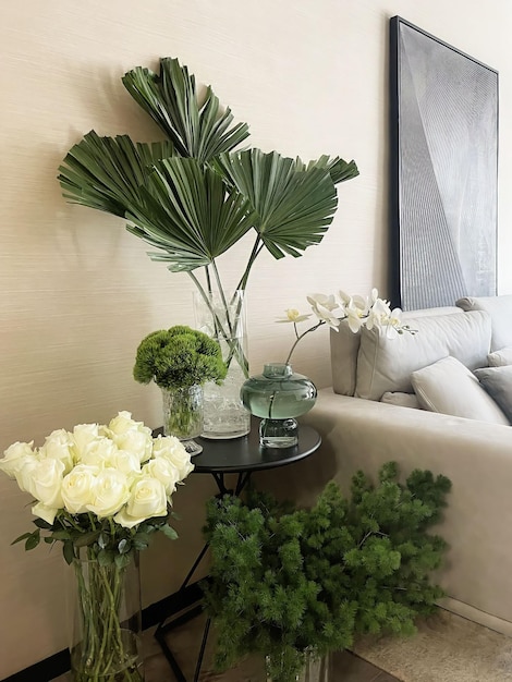 A living room with a couch and a vase of flowers on a table with a vase of flowers.