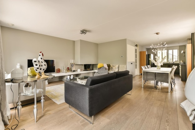 a living room with couches chairs and a television in the center of the room is on the wall