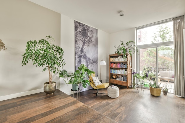 A living room with plants and a large window