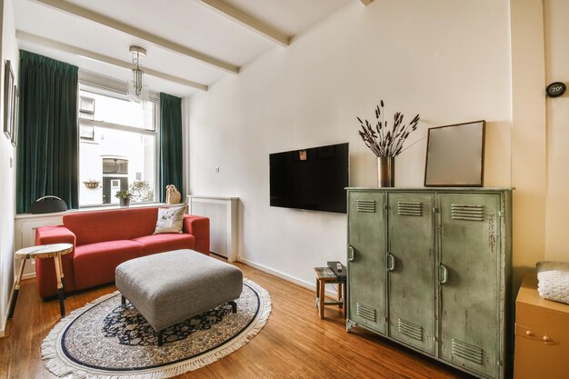 A living room with a red couch and a tv