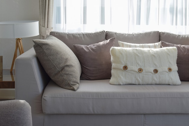 Living room with row of grey pillows on sofa at home