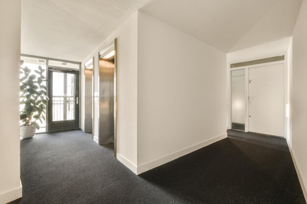 A living room with white walls and a black carpet