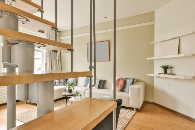 a living room with wood flooring and white walls including an open staircase leading up to the second floor