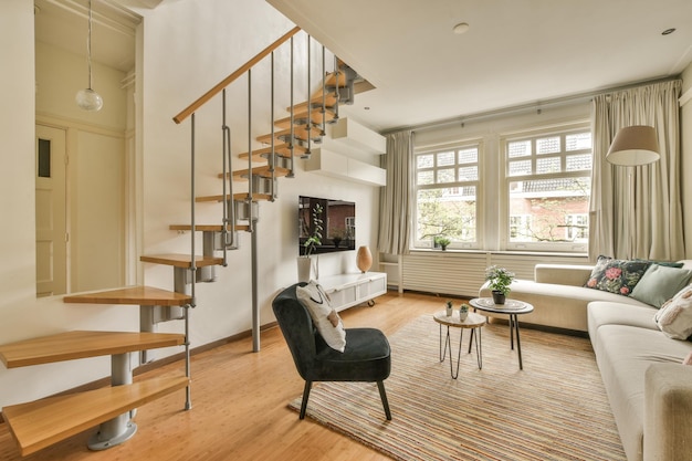 a living room with wood flooring and wooden stairs leading up to the second floor in an apartment at home