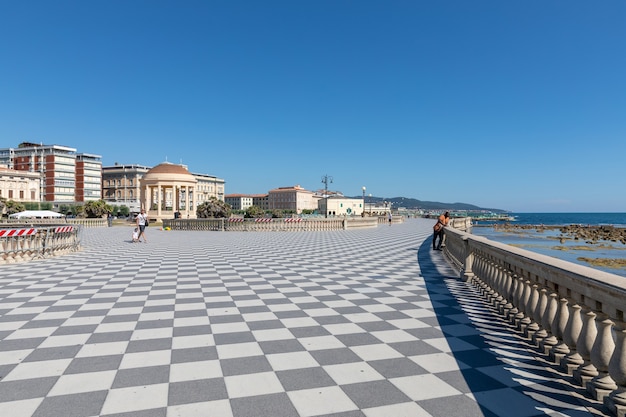 Livorno, Italy - June 29, 2018: Panoramic view of Terrazza Mascagni (Mascagni terrace) in front of the Ligurian sea on the western coast of Tuscany in Livorno. People walk and rest on terrace