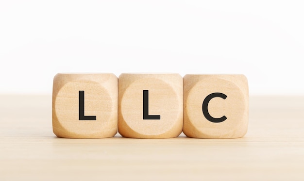 LLC or Limited Liability Company concept Tex on wooden blocks on table Copy space