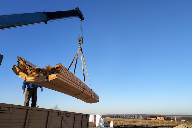 Load boards supplied to the construction site with a crane manipulator