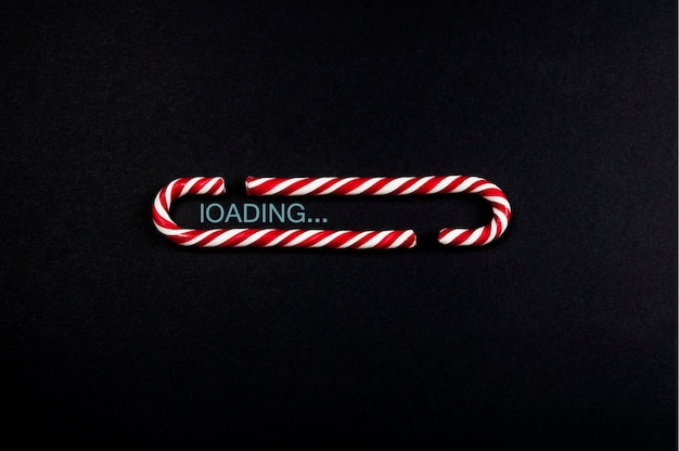 Loading bar made of Christmas candies on a black matte background