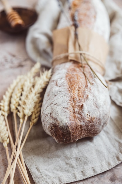 Loaf of artisan sourdough bread with lavender and honey with wheat ears Traditional artisan bread