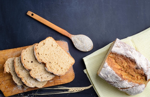 Loaf of bread on wooden background food closeup