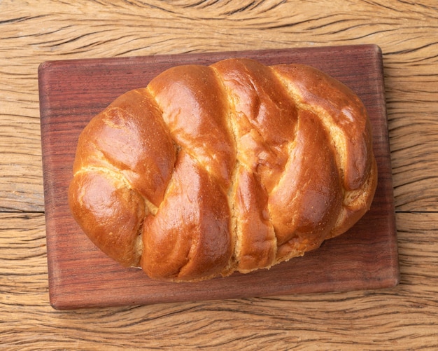 Loaf of brioche bread over wooden table