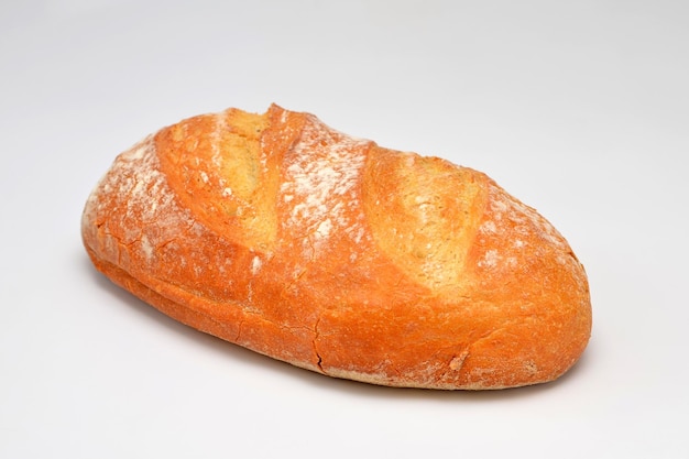 Loaf of fresh wheat bread isolated on white background