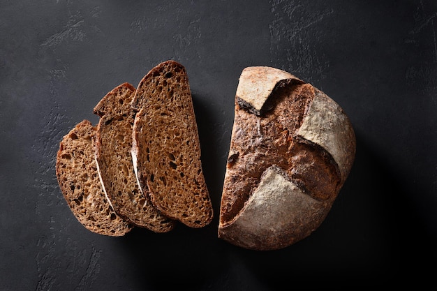 Loaf of freshly baked bread with hemp flour on black