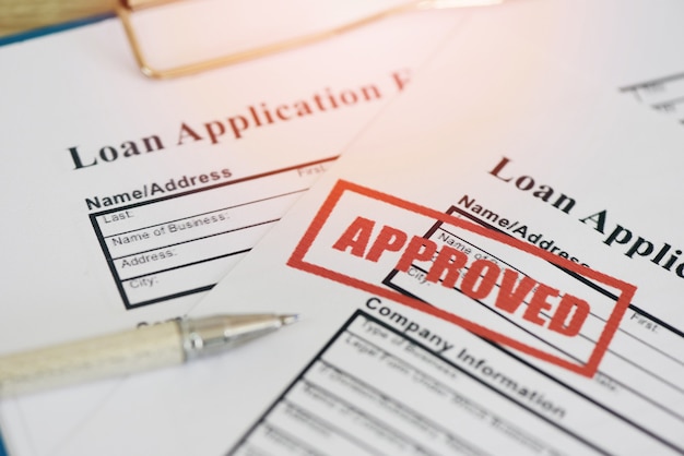 Loan application form with Rubber stamping that says Loan Approved, Financial loan approval