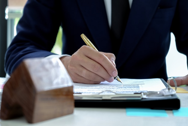 Loan officers are signing approving funds to buy houses.