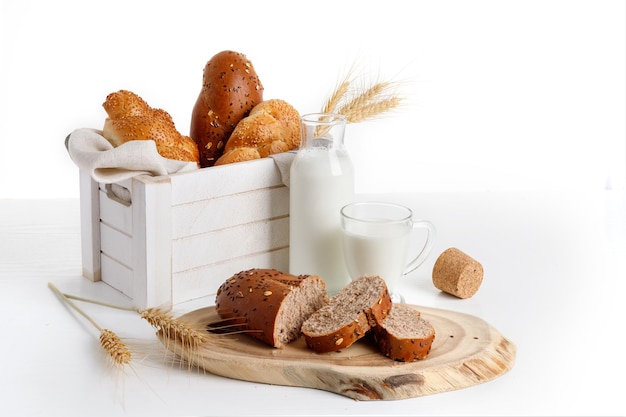 Loaves of bread in a white wooden box milk wheat ears