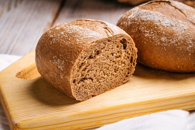 Loaves of rye bread on the wooden board