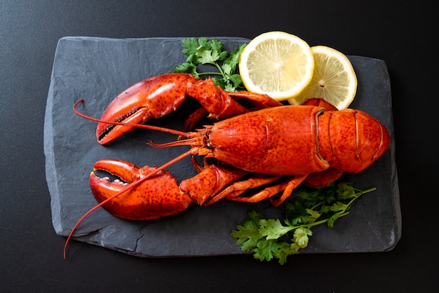 lobster with vegetable and lemon on black slate plate