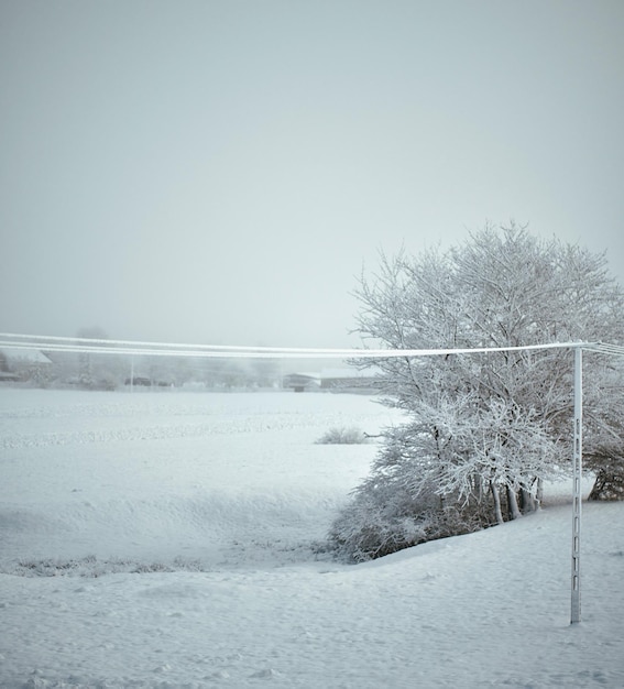 Local electric pole covered with ice and snow Concept of electricty and blackouts problem during winter snowstroms in rural areas