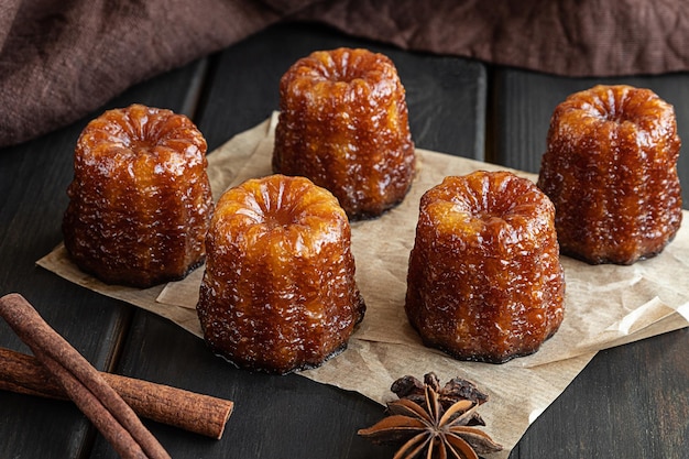 Local french dessert canele on a dark wooden background