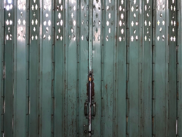 Local vintage Asian steel green door from inside building