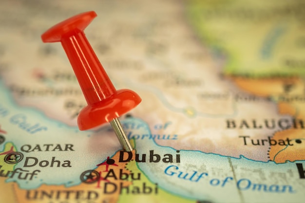 Location Dubai in United Arab Emirates travel map with push pin point marker closeup Asia journey concept