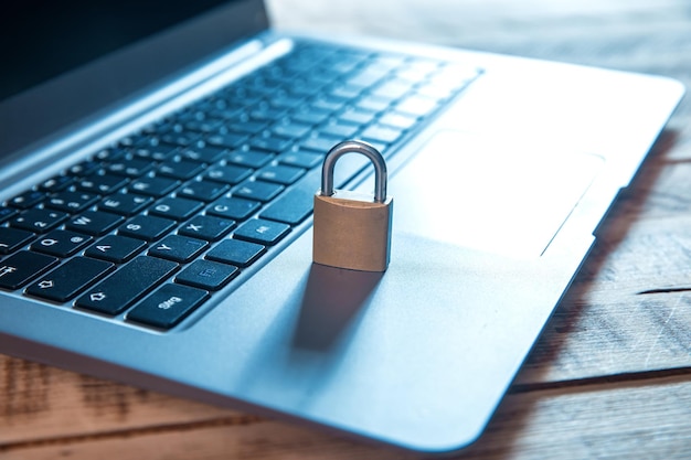 Lock on computer keyboard on the wooden tablexA